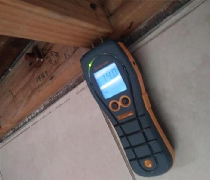 Framing with moisture meter reading 14 and green light