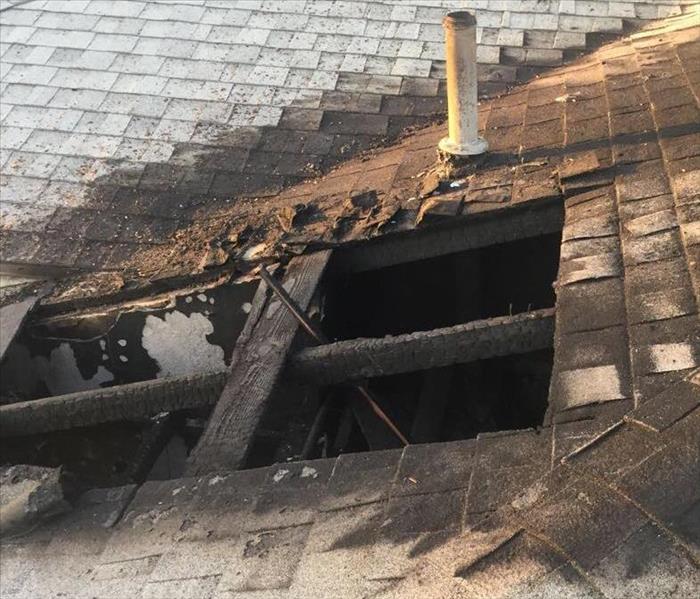 fire damage hole in roof exposed structure