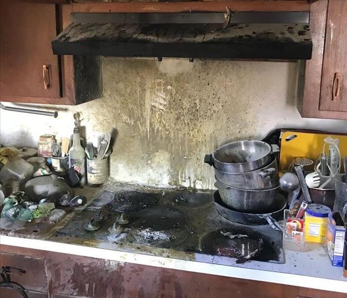 A Stove Fire that damaged the surrounding kitchen cabinets and countertops.