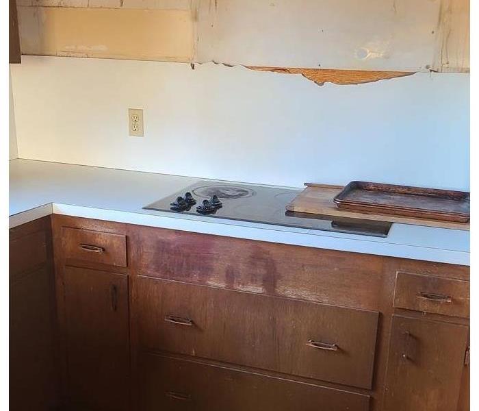 Kitchen Restored with a cleaned countertop & lower cabinets with the upper cabinets removed.